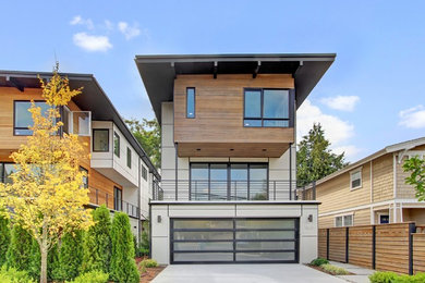 Inspiration for a mid-sized modern gray three-story mixed siding flat roof remodel in Seattle
