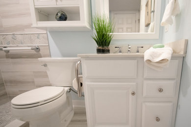Small 3/4 beige tile and porcelain tile porcelain tile, beige floor and single-sink bathroom photo in DC Metro with raised-panel cabinets, white cabinets, a two-piece toilet, blue walls, an undermount sink, quartz countertops, beige countertops and a built-in vanity