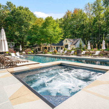 Spa and pool deck with the cabana and home framing the backyard retreat