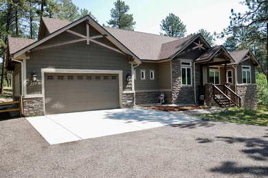 Inspiration for a mid-sized craftsman one-story mixed siding exterior home remodel in Denver with a shingle roof