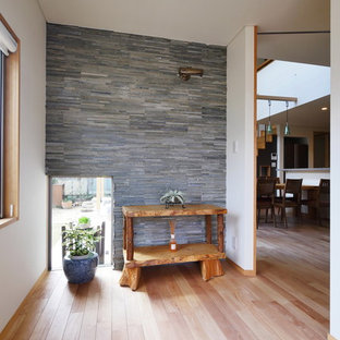 他の地域のアジアンスタイルのおしゃれな玄関 (白い壁、淡色無垢フローリング、茶色い床) の写真