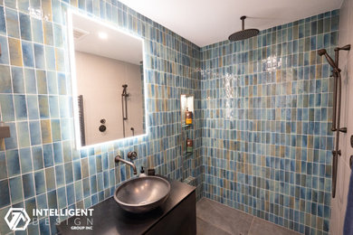 Master blue tile and ceramic tile ceramic tile, gray floor and single-sink bathroom photo in Toronto with brown cabinets, a one-piece toilet, gray walls, a vessel sink, glass countertops, brown countertops and a floating vanity