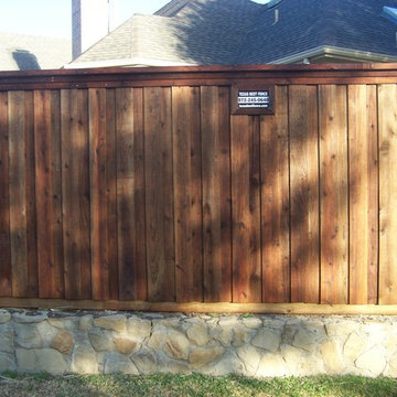 Board on Board Cedar Fence Stone Retaining Wall