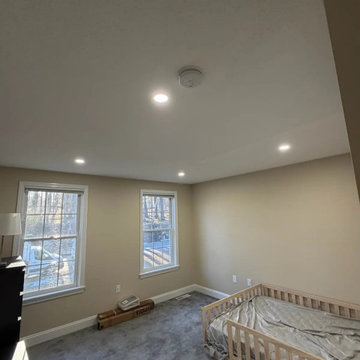 A bedroom lit evenly with code-required smoke detection