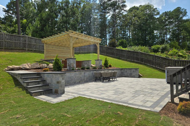 Inspiration for a mid-sized timeless backyard concrete paver patio remodel in Raleigh with a pergola