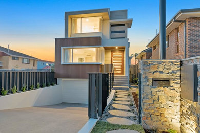 Large modern three-storey multi-coloured house exterior in Gold Coast - Tweed with a flat roof.