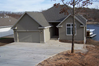 Inspiration for a beige two-story stucco exterior home remodel in Other