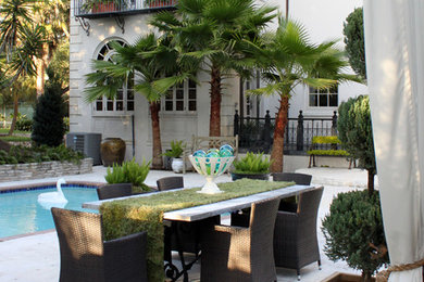 Example of a large eclectic backyard tile patio design in Houston with a pergola