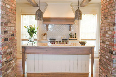 Kitchen - small traditional kitchen idea in Other with an island