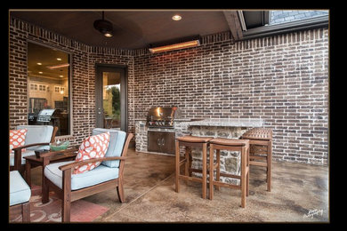 Mid-sized elegant backyard patio kitchen photo in Oklahoma City with a roof extension