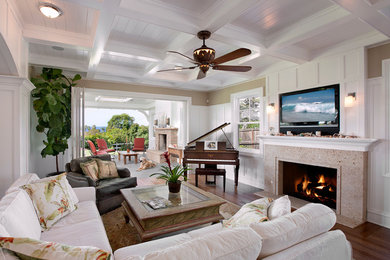Living room - mid-sized traditional open concept dark wood floor living room idea in Santa Barbara with beige walls, a standard fireplace, a stone fireplace and a wall-mounted tv