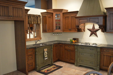 Enclosed kitchen - large rustic l-shaped ceramic tile and beige floor enclosed kitchen idea in Philadelphia with a double-bowl sink, recessed-panel cabinets, dark wood cabinets, granite countertops and stainless steel appliances