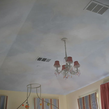 Clouds painted on ceiling in kids rooms