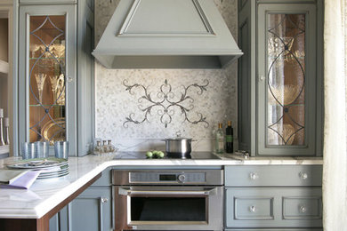 Inspiration for a small victorian u-shaped medium tone wood floor eat-in kitchen remodel in New York with a drop-in sink, stainless steel appliances, an island, recessed-panel cabinets, marble countertops, white backsplash, marble backsplash and gray cabinets