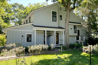 Mid-sized trendy gray two-story mixed siding exterior home photo in Providence with a shingle roof and a brown roof