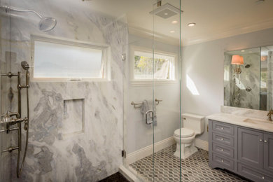 Photo of a mid-sized contemporary master bathroom in San Francisco with recessed-panel cabinets, grey cabinets, gray tile, white tile, stone slab, marble benchtops, a corner shower, a one-piece toilet, grey walls, mosaic tile floors and an undermount sink.