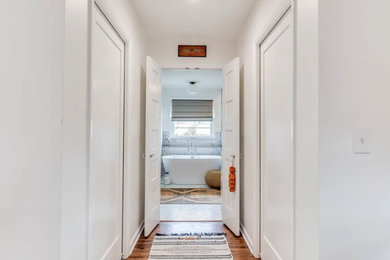 Mid-sized trendy brown floor hallway photo in Nashville with white walls