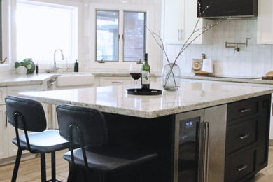 Inspiration for a large transitional u-shaped ceramic tile and brown floor eat-in kitchen remodel in Phoenix with shaker cabinets, black cabinets, granite countertops, white backsplash, stainless steel appliances, an island and white countertops