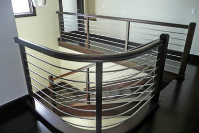 Staircase - contemporary wooden u-shaped wood railing staircase idea in Orange County with wooden risers