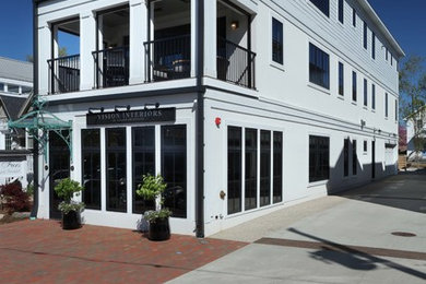 Transitional white three-story apartment exterior idea in Grand Rapids