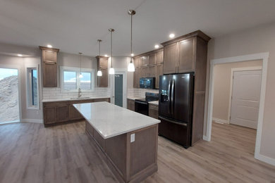 Inspiration for a mid-sized timeless l-shaped vinyl floor and brown floor eat-in kitchen remodel in Other with an undermount sink, flat-panel cabinets, brown cabinets, quartz countertops, white backsplash, ceramic backsplash, black appliances, an island and white countertops