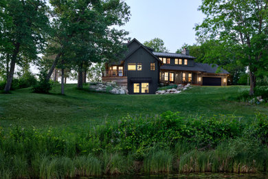 Coastal brown three-story mixed siding house exterior idea in Minneapolis with a mixed material roof