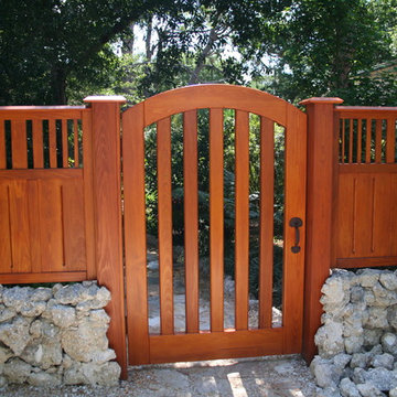 Cypress gate with fencing plus landscaping and hardscape .