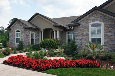 Example of a large transitional brown one-story mixed siding exterior home design in Jacksonville with a shingle roof