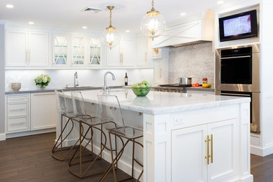 Example of a transitional l-shaped dark wood floor kitchen design in Boston with shaker cabinets, white cabinets, gray backsplash, stainless steel appliances and an island