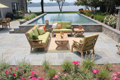 Mid-sized minimalist backyard stone patio photo in Baltimore
