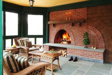 Mid-sized classic stone screened-in back porch idea in Boston with a roof extension