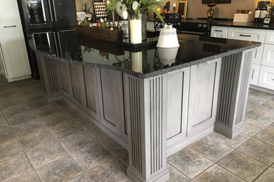 Kitchen - traditional kitchen idea in Other with granite countertops