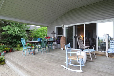 Inspiration for a country backyard patio remodel in Toronto with decking and a roof extension