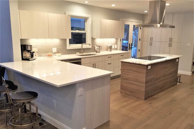Inspiration for a modern kitchen in Denver with a submerged sink, flat-panel cabinets, white cabinets, engineered stone countertops, multi-coloured splashback, glass tiled splashback, stainless steel appliances, medium hardwood flooring, an island, beige floors and multicoloured worktops.