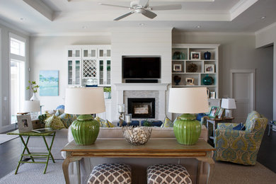Design ideas for a mid-sized beach style open concept family room in Jacksonville with white walls, dark hardwood floors, a standard fireplace, a stone fireplace surround, a wall-mounted tv and brown floor.