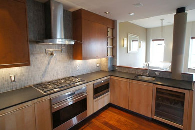 Example of a mid-sized minimalist u-shaped light wood floor kitchen design in Boston with gray backsplash, porcelain backsplash and stainless steel appliances