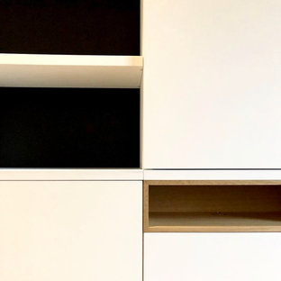 Inspiration for a large contemporary light wood floor home theater remodel in Toulouse with black walls and a wall-mounted tv