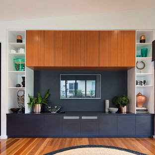 Inspiration for a small modern open concept medium tone wood floor and multicolored floor home theater remodel in Brisbane with blue walls