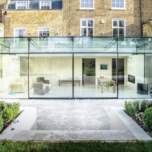 This is an example of a large contemporary one floor glass exterior in London.