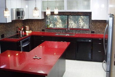 Design ideas for a modern l-shaped eat-in kitchen in London with a double-bowl sink, flat-panel cabinets, dark wood cabinets, marble benchtops, white floor and red benchtop.