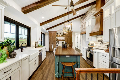 Large cottage u-shaped vinyl floor, brown floor and vaulted ceiling eat-in kitchen photo in Other with a farmhouse sink, recessed-panel cabinets, white cabinets, quartz countertops, beige backsplash, porcelain backsplash, stainless steel appliances, an island and white countertops