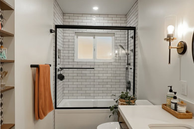 Inspiration for a mid-sized transitional kids' white tile and ceramic tile ceramic tile, black floor and single-sink bathroom remodel in San Diego with flat-panel cabinets, medium tone wood cabinets, a one-piece toilet, white walls, an undermount sink, quartz countertops, white countertops, a niche and a built-in vanity
