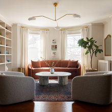 living room with fireplace, bay window and 2 entryways