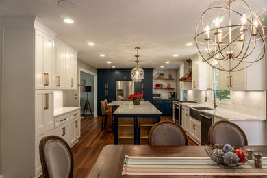 Brown floor eat-in kitchen photo in Cleveland with a farmhouse sink, shaker cabinets, blue cabinets, quartz countertops, ceramic backsplash, an island and white countertops