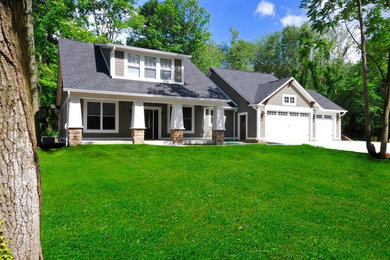 Inspiration for a mid-sized craftsman green two-story mixed siding gable roof remodel in Indianapolis