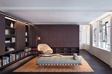 Living room - large modern dark wood floor living room idea in New York with white walls, no fireplace and a concealed tv
