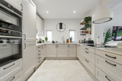 Inspiration for a medium sized kitchen in Other with shaker cabinets, beige cabinets, quartz worktops, black appliances, beige floors and white worktops.