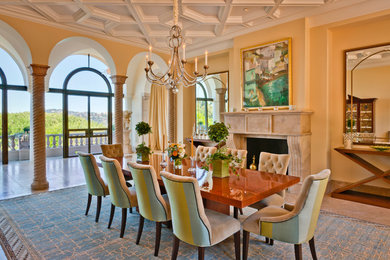 Inspiration for a huge timeless marble floor and brown floor enclosed dining room remodel in San Francisco with yellow walls, a standard fireplace and a stone fireplace