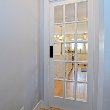 White Multi-Pane Sliding Glass Door in the Entry Hall | The Junction