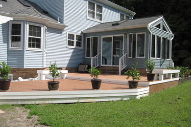 Inspiration for a mid-sized transitional backyard deck remodel in Other with a pergola